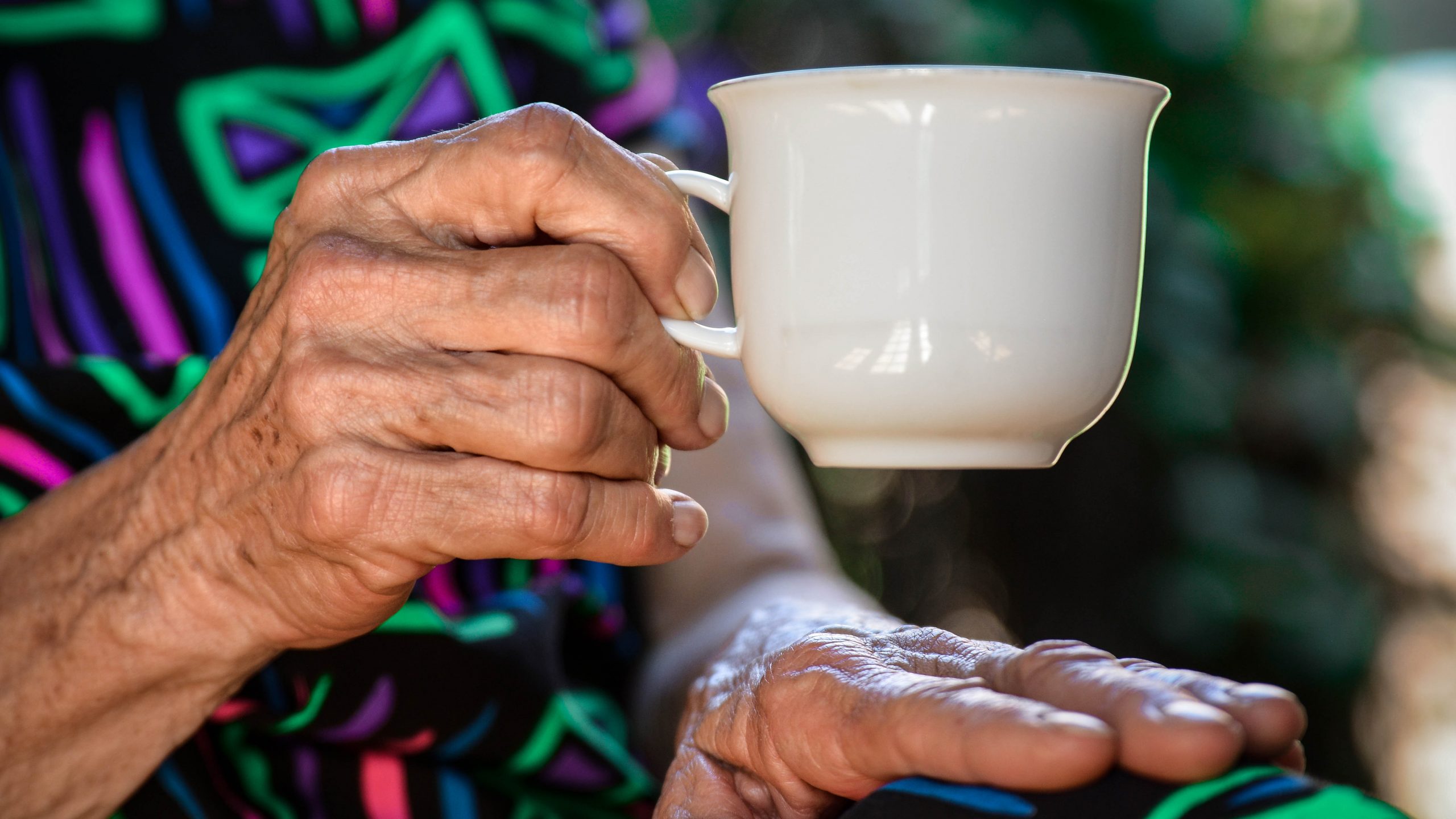elderly lady hand with a cup of tea