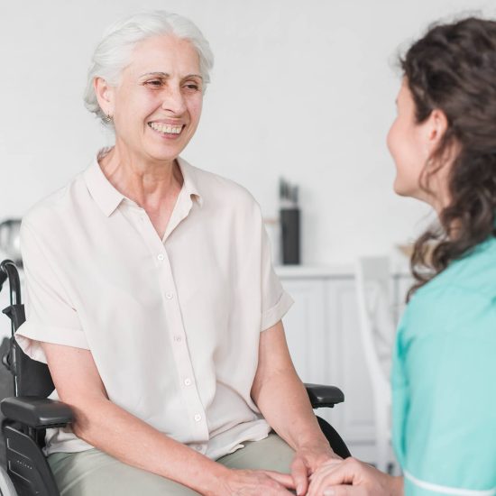 carer holding hands with elderly person